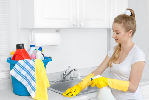 Professional Airbnb cleaner sanitizing kitchen surfaces